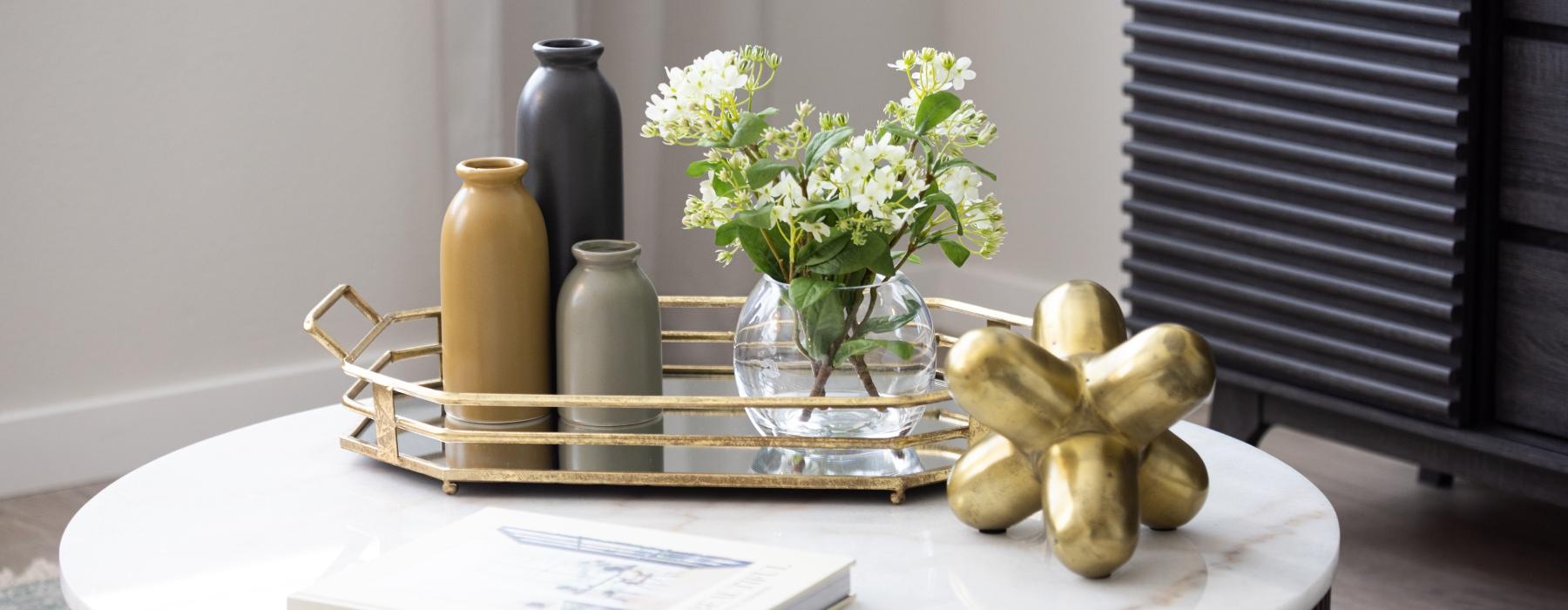 a table with a vase of flowers and a book on it