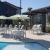 pool area with reclining seats and landscaping