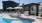 pool area with reclining seats and landscaping