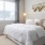 bedroom with a large window and modern decor