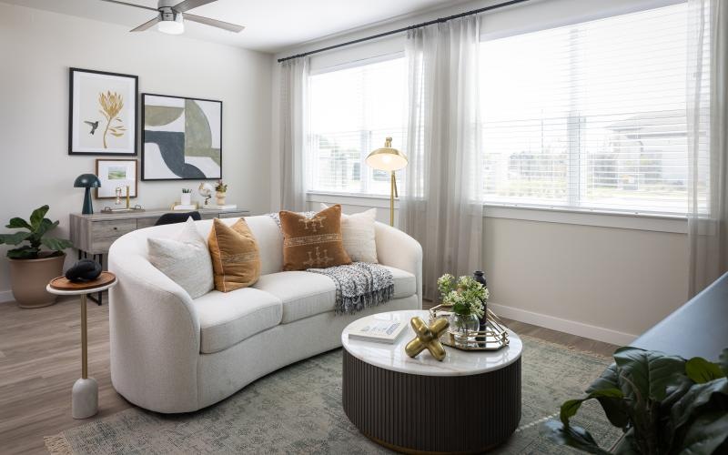 a living room with a white couch and a coffee table
