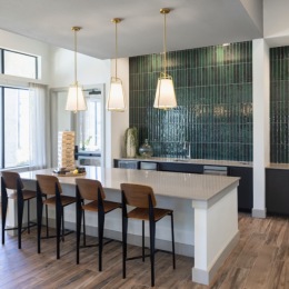 lounge area with bar-style seating, high ceilings, and large open windows