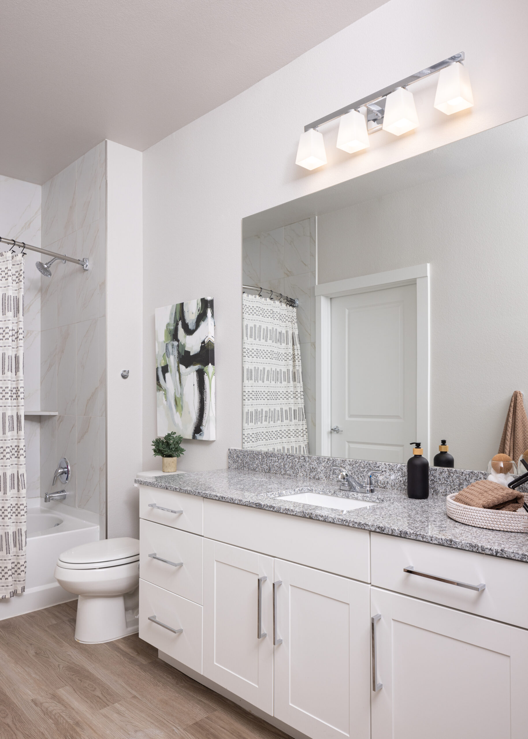 bathroom with large mirror and shower in the background at prose evergreen in new braunfels, tx