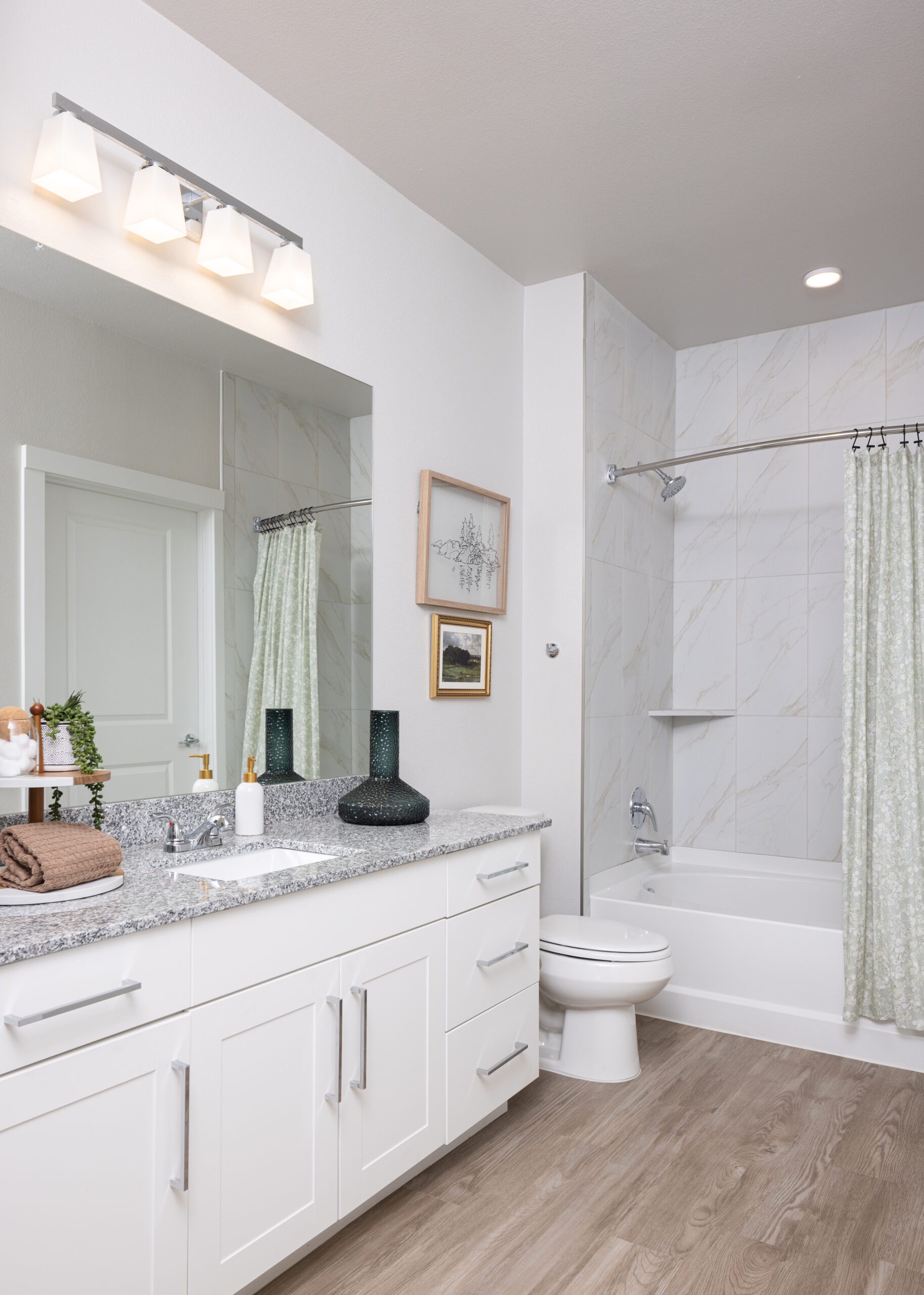 bathroom with large mirror and shower in the background at prose evergreen in new braunfels, tx