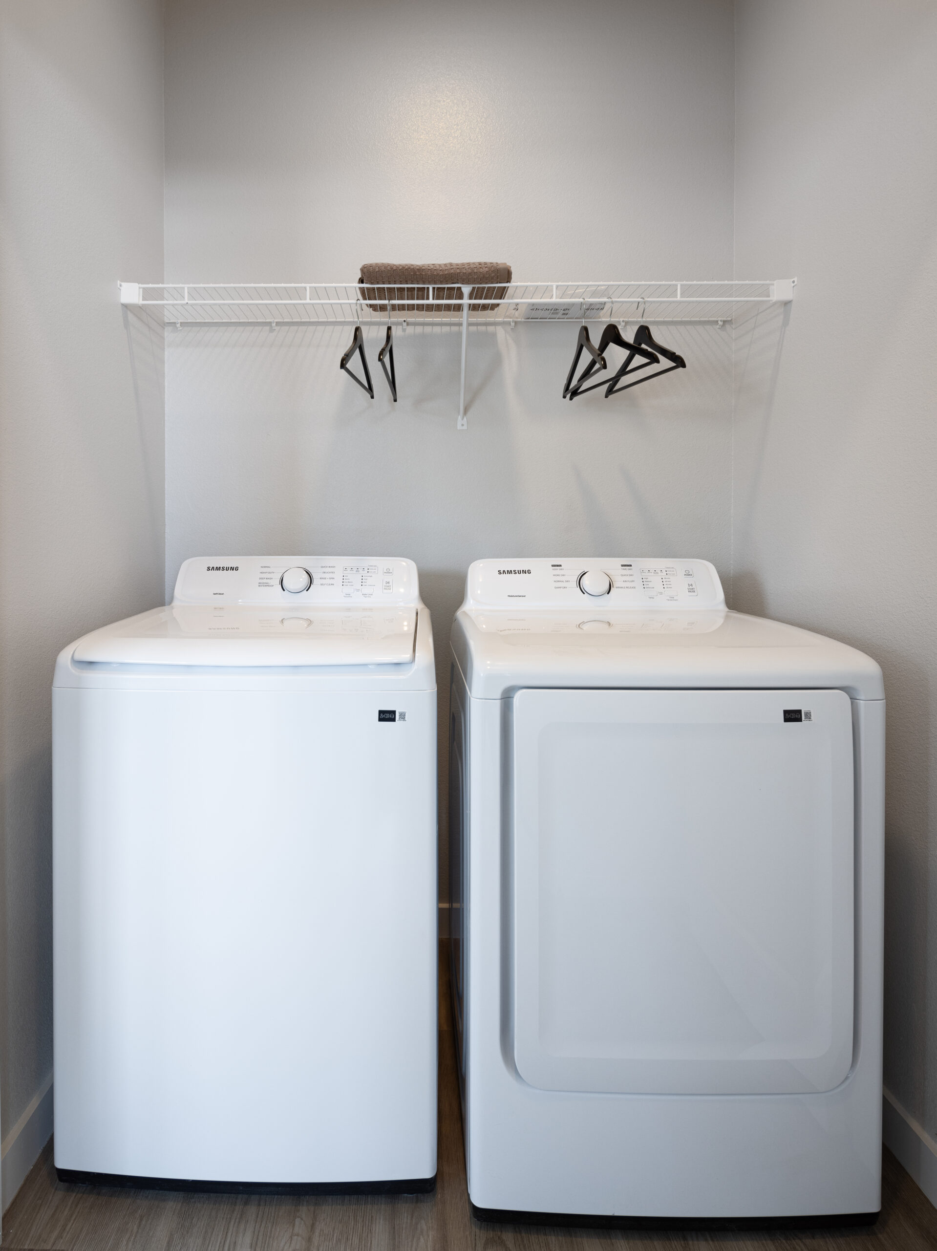 laundry room with full size white washer and dryers included at prose evergreen in new braunfels, tx